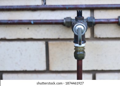 Copper Pipe Line For Natural Gas Water Heater System Built Outside Of Brick Wall Showing Safety Valve Fitting Can Be Assess By Owner Or Landlords