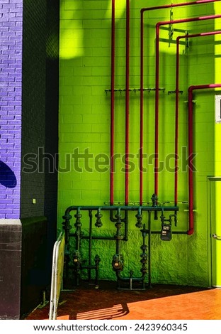 Copper pipes exposed in a colorful alley