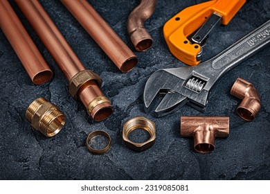 Copper Pipes And Fitting Connectors For Plumbing On Black Background