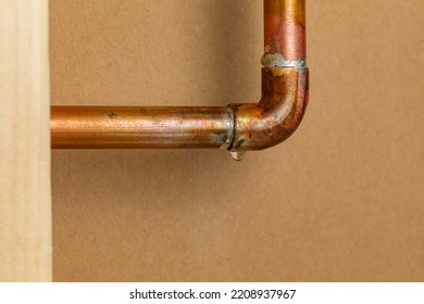 Copper Plumbing Pipe Leaking Water Inside Wall. Home Repair, Maintenance And Remodeling Concept.