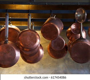  Copper pots and pans hanging in a kitchen                              