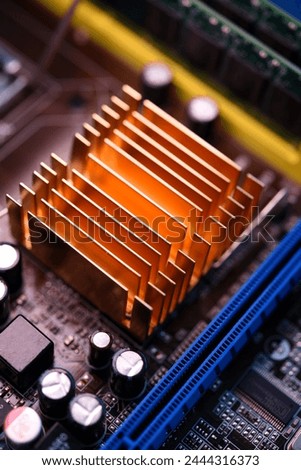 A copper radiator for cooling the chip on the computer board. Radio components.The computer's motherboard.