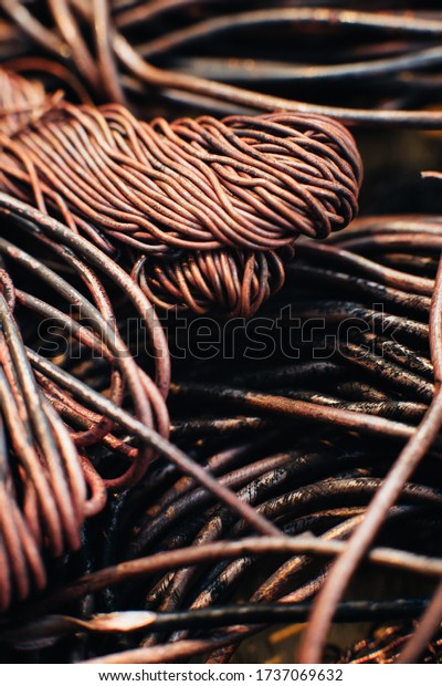 Copper\
scrap metal, wire, windings of motors and transformers, electrical\
wire without insulation. Calcined oxidized copper wire. Against the\
background of a copper sheet. Close-up.\
Macro.