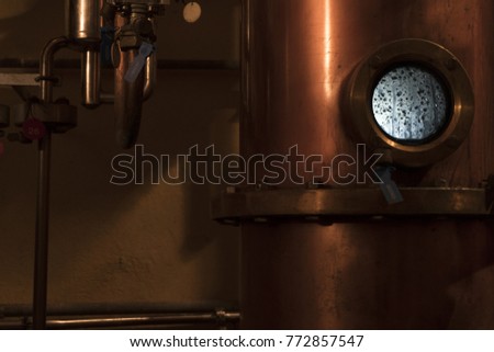 Copper still alembic inside distillery to distill grapes and produce spirits 
