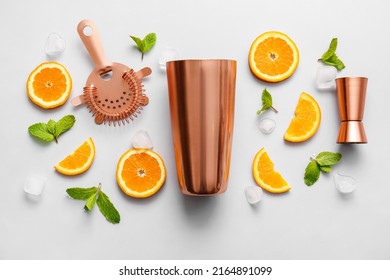 Copper Strainer, Cobbler Shaker, Double Jigger And Cocktail Ingredients On Grey Background