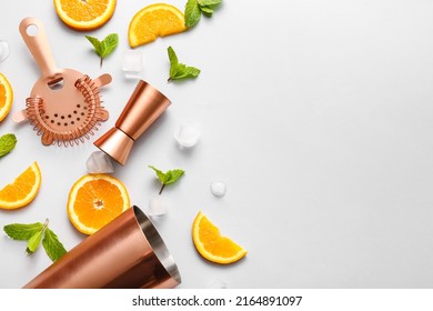 Copper Strainer, Double Jigger, Cobbler Shaker And Cocktail Ingredients On Grey Background