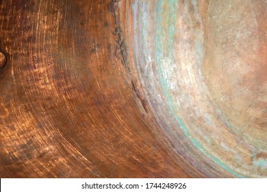 Copper surface of the inner wall of the copper pot. Green circles of copper oxidation. Copy space.