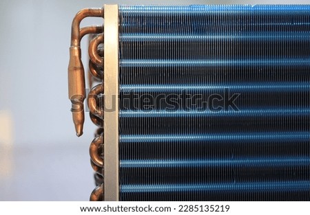 Copper tubes and aluminum fins coated with blue paint serve for heat dissipation in widely used heat exchangers such as air conditioner dehumidifier refrigerant system type.