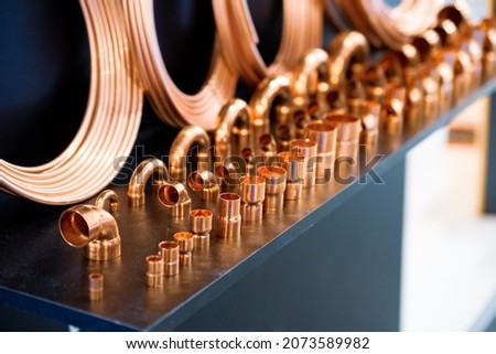 Copper tubes, copper corners and connections. Shallow depth of field
