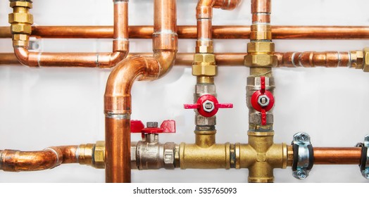 Copper Valves And Pipes On A White Wall