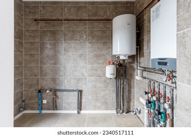 Copper valves, stainless ball valves, detectors of water pressure and plastic pipes of central heating system and water pipes with thermal insulation in the boiler room in apartment during under - Shutterstock ID 2340517111