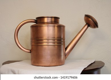 A Copper Watering Can That Had Irregular Tarnish Removed And A Layer Of Wax Applied Afterward.