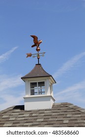 Copper Weathervane On Top Of Home, With Blue Skies Beyond