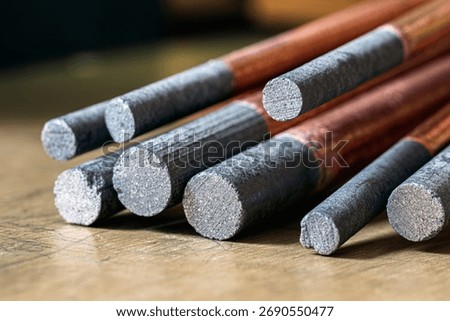 Copper-plated carbon electrode, bundle of rods made from rare earth materials, close-up view
