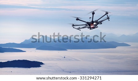 Copter flight over the Mediterranean Sea with the mountains in the background a beautiful sunset.