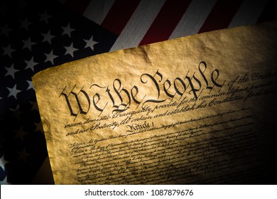 A copy of the Constitution of the United Sates of American on a flag of the USA - Shutterstock ID 1087879676
