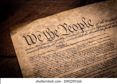 A copy of the Constitution of the United Sates of American on a wooden background - Shutterstock ID 1092295166