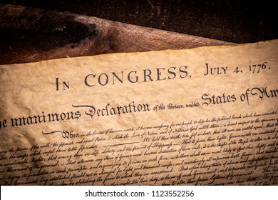 A copy of the declaration of Independence of the United States on a wooden table - Shutterstock ID 1123552256