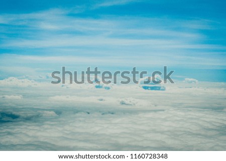 Copy space of airplane view above cloud summer blue sky and sun light abstract nature background.