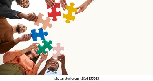 Copy Space Banner Background With Diverse Multiracial Team Of Happy Adult Men And Women Who Work Together Holding Colorful Pieces Of Jigsaw Puzzle. Business, Education, Innovation And Teamwork Concept