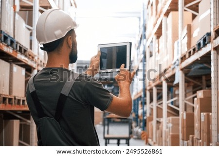 Copy space, holding digital tablet. Foreman is in the storehouse, shipping distribution business.