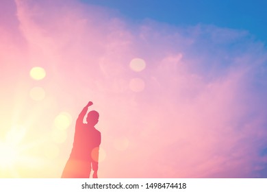 Copy space of man hand raising on top of mountain and sunset sky abstract background. Freedom travel adventure and business victory concept. Vintage tone filter effect color style. - Shutterstock ID 1498474418