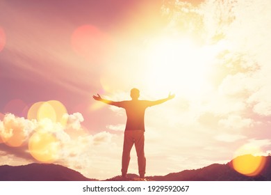 Copy space of man hand raising on top of mountain and sunset sky abstract background. Freedom travel adventure and business victory concept. Vintage tone filter effect color style.