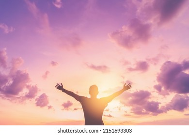 Copy space of man rise hand up on sunset sky at beach and island background. Freedom and travel adventure concept. Vintage tone filter effect color style. - Shutterstock ID 2151693303