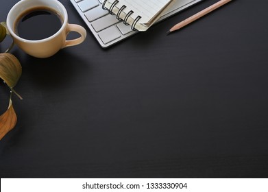 Copy Space Office Desk Coffee, Computer Keyboard And Notepad With Pencil On Black Table.