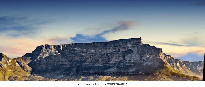 Copy space with scenic landscape of Table Mountain in Cape Town with cloudy blue sky background. Steep rocky mountainside with green valley. Breathtaking and magnificent views of the beauty in nature - Powered by Shutterstock