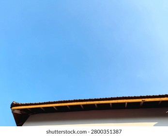 Copy space template concept featuring vibrant clean blue sky backdrop with residential building eaves