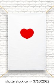 Copy Space For Text And Red Heart Shape On Disastrously White Vinyl Banner On White Brick Background .Clipping Path .vertical