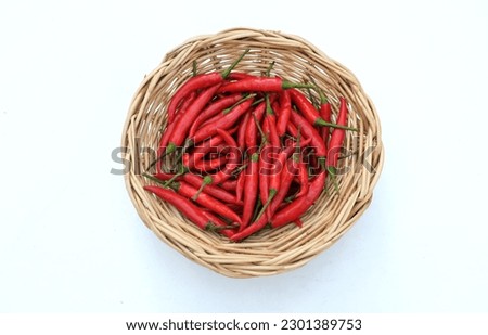 copy space and top view heap of fresh bunch ripe red hot chili peppers in a bamboo basket isolate on a white background. food concept herbs vegetables healthy