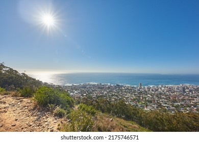 Copy Space With Views From Table Mountain In Cape Town South Africa Of A Clear Blue Sky Over A Coastal City. Scenic Landscape Of Buildings In An Urban Town Along The Mountain And Sea On A Sunny Day