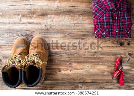Copy space work tool equipment - working shoes, dress and screwdrivers on wood table. Top view.