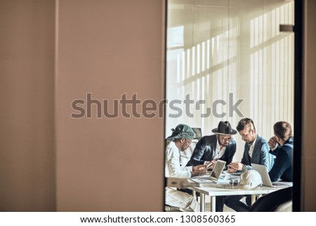 copy space. young ambitious men concentrated on working in the office