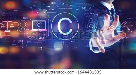 Copyright concept with businessman on night city background
