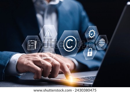 Copyright or patent concept. Author rights and patented intellectual property. copyleft trademark license. Businessman use laptop with copyright icon on virtual screen. 