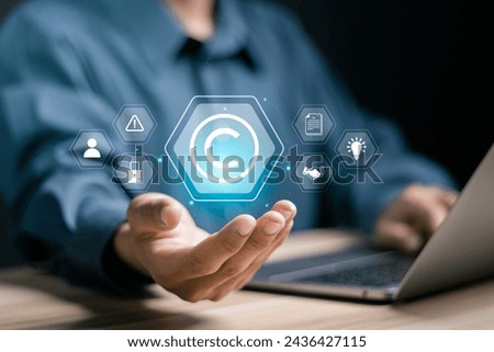 Copyright or patent concept. Author rights and patented intellectual property. copyleft trademark license. Businessman showing copyright icon on virtual screen.
