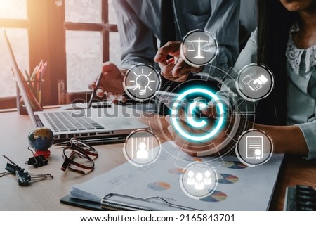 Copyright or patent concept, Business team analyzing data and using smart phone on desk with VR screen copyright icon background, Copyleft trademark license, Creation ownership against piracy .