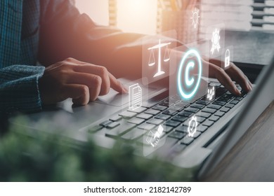 Copyright or patent concept, Person hand using laptop computer on desk with VR screen copyright icon background, Copyleft trademark license, Creation ownership against piracy crime.