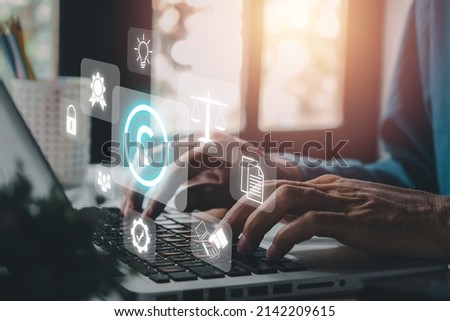 Copyright or patent concept, Person hand using laptop computer on desk with VR screen copyright icon background, Copyleft trademark license, Creation ownership against piracy crime	