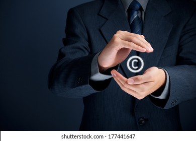 Copyright, patents and intellectual property protection law and rights. Author with protective gesture and copyright symbol. 