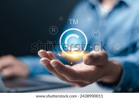 Copyright protection concept. Registration or registration for trademark, Register trademark. Businessman holding copyright icon and logo on virtual screen.