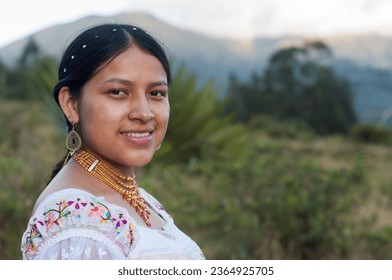 copy-space of beautiful young latin american girl looking at smiling camera with traditional indian dress and gold necklaces. Hispanic Heritage Month