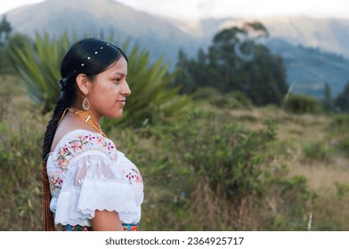 copy-space of an indigenous girl from ecuador in indigenous clothing looking in profile to the camera, the girl is in the mountains. Hispanic Heritage Month - Shutterstock ID 2364925717