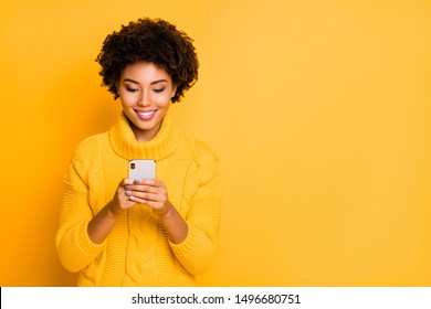 Copyspace photo of cheerful cute charming girlfriend browsing through her smartphone wearing pullover addicted to social media isolated with vibrant color background - Powered by Shutterstock