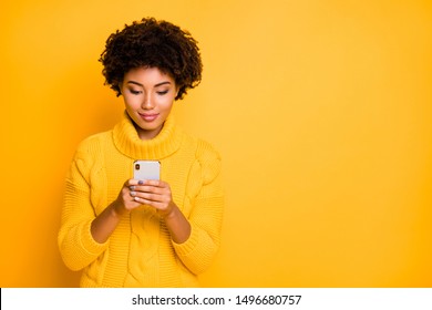 Copyspace photo of cheerful cute fascinating pretty sweet girlfriend wearing yellow pullover while holding telephone with hands isolated with vivid background - Shutterstock ID 1496680757
