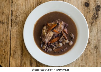 Coq Au Vin Natural Light From On Plate From Above. Classic French Chicken Dish Prepared Served With Vegetables In Red Wine