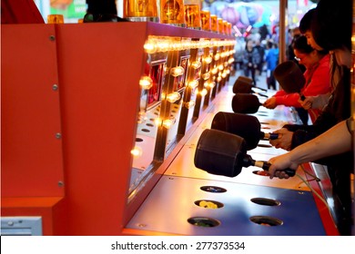 Coquitlam, BC, Canada - April 09, 2015 : People playing whack game at carnival